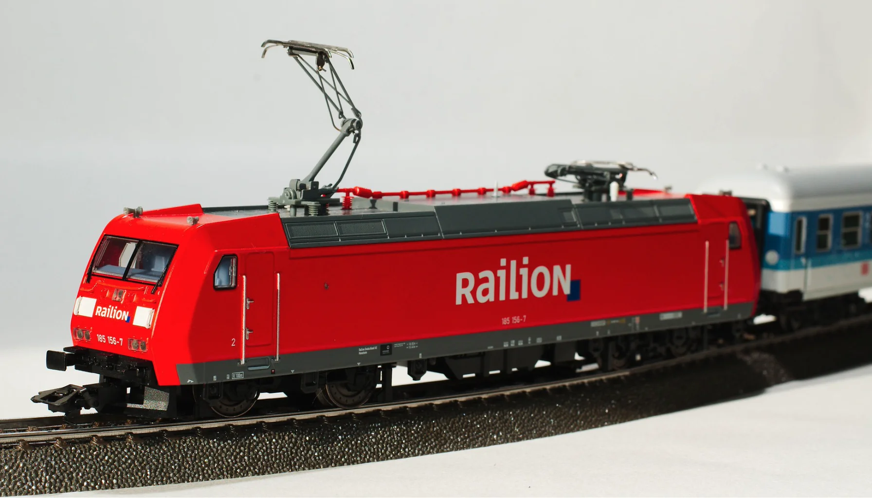 Photo of a Märklin red Railion model train with wagon on a model railway
